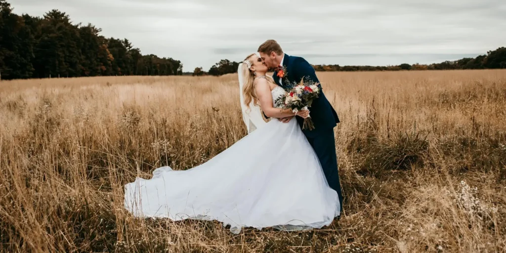 Plan an Unforgettable Celebration at Brooks Estate kiss in the field at a wedding at watson estate deer creek winery