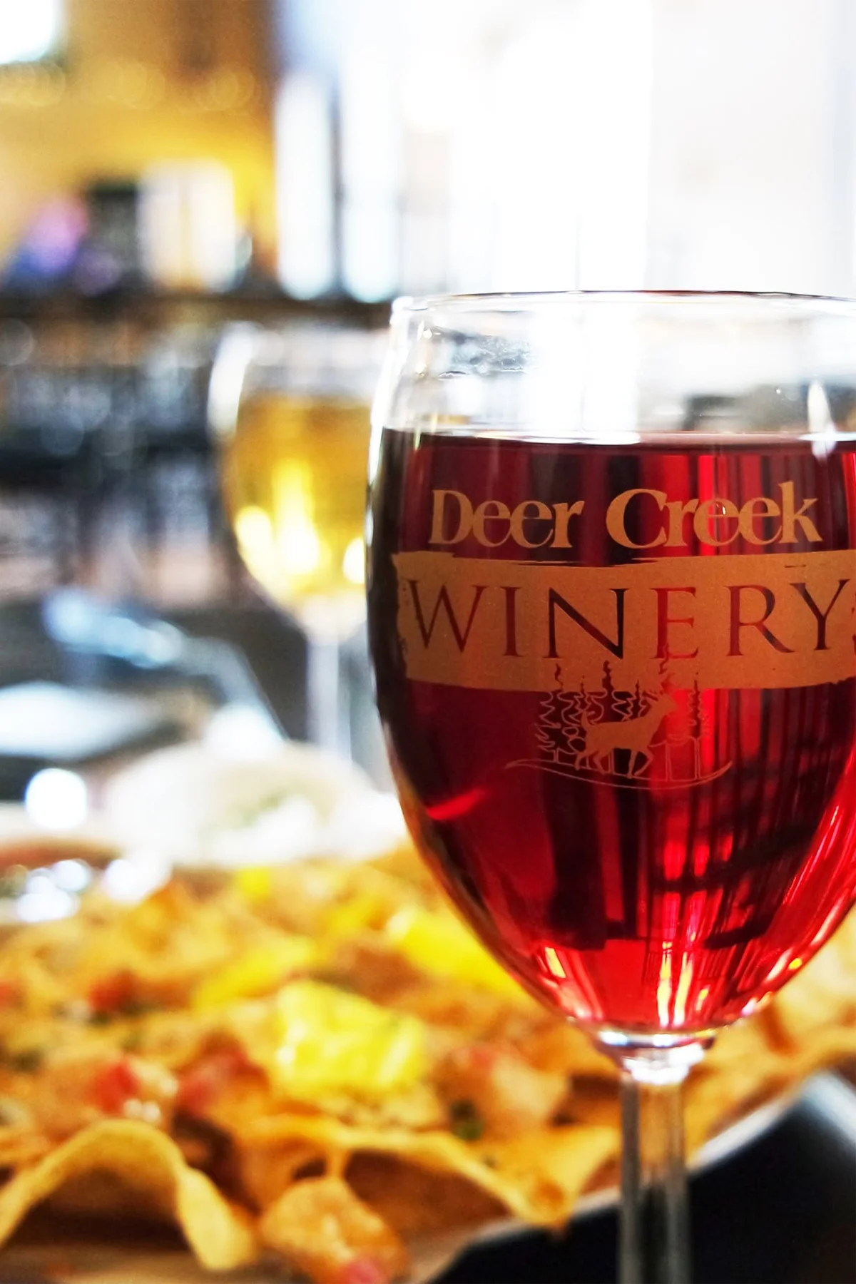 A glass of Deer Creek Winery red wine on the tasting room bar in Pennsylvania