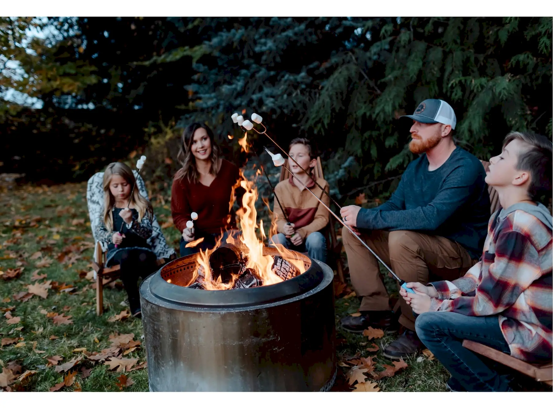 Compare Estates group of people sitting around a campfire at deer creek winery at brooks estate