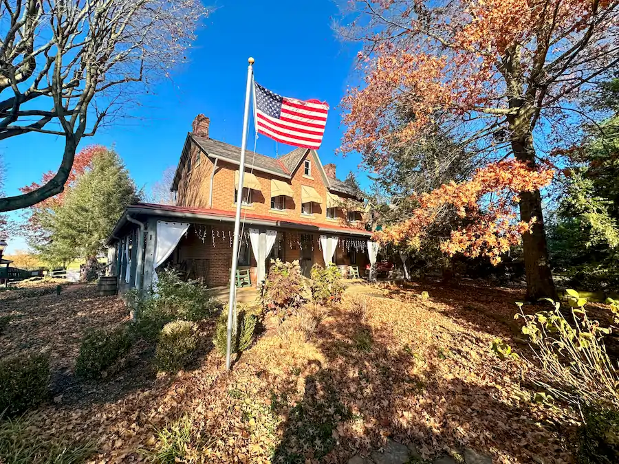 Host An Event at Watson Estate WE. Outside Estate House with flag