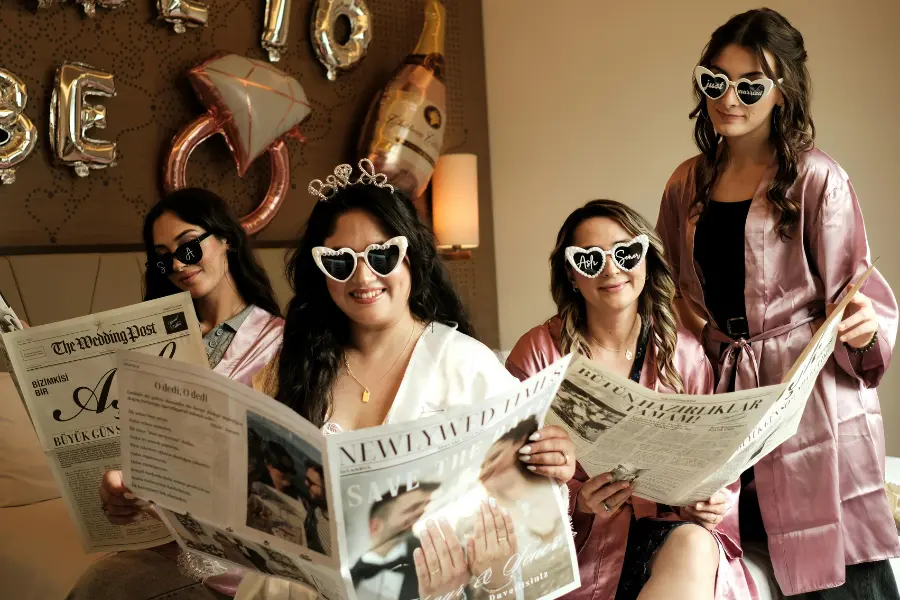 Why a Winery Bridal Shower in Pennsylvania Is the Perfect Celebration Bridal Party Celebrating with Heart Glasses and Newspapers