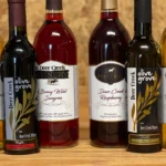 Deer Creek Winery Pairing Experience lineup — Sunset Steuben, Maple Balsamic Vinegar, Berry Wild Sangria, Raspberry wine, Garlic Olive Oil, and Fryburg White