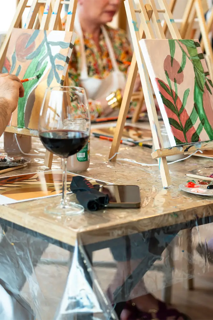 Sip and Paint Event. Art class with friends enjoying painting and wine