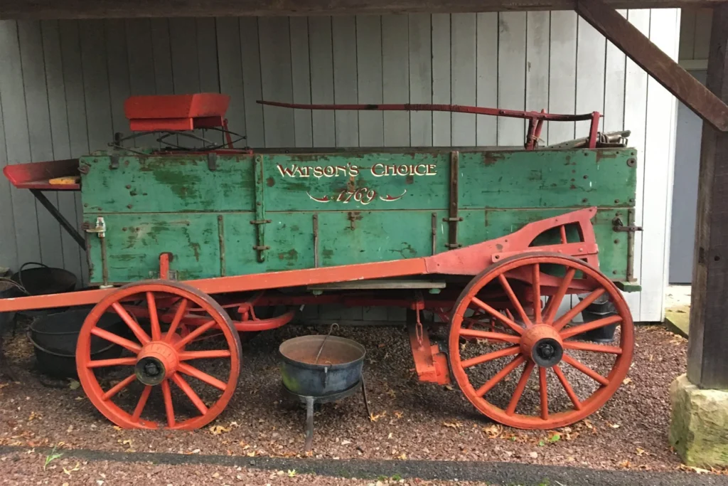 deer creek winery at watson estate green and red watson's choice wagon under a shed