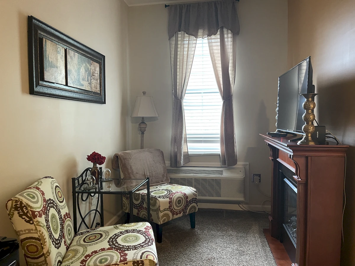 autumn in italy room, chairs in sitting area with tv