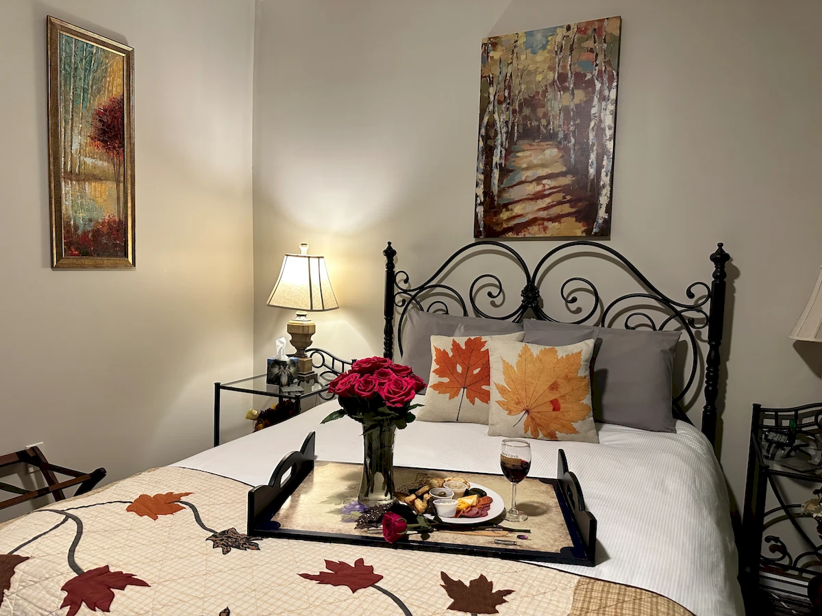 autumn in italy room, tray of breakfast and flowers on bed