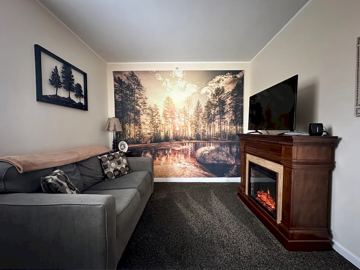 deer creek room, sitting area with couch, tv and electric fireplace