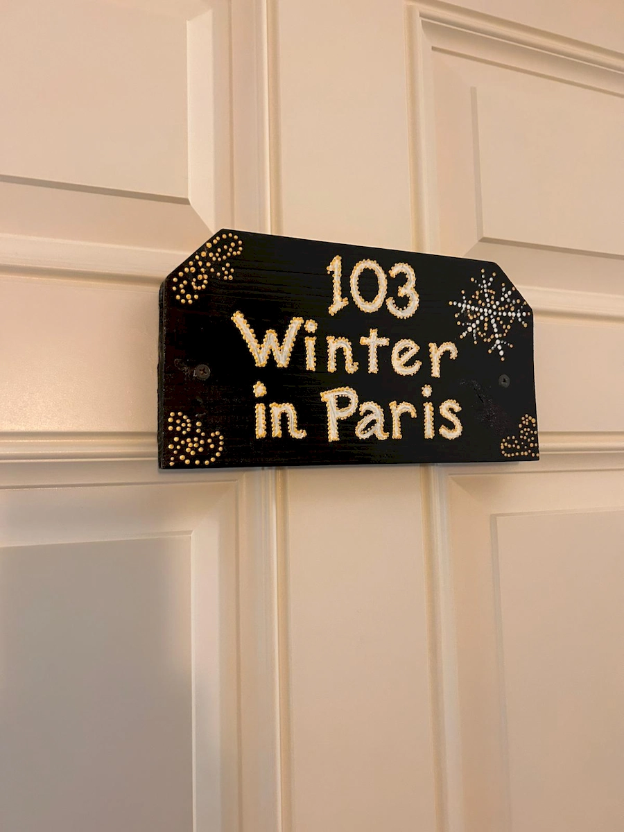 winter in paris room 103 sign on door
