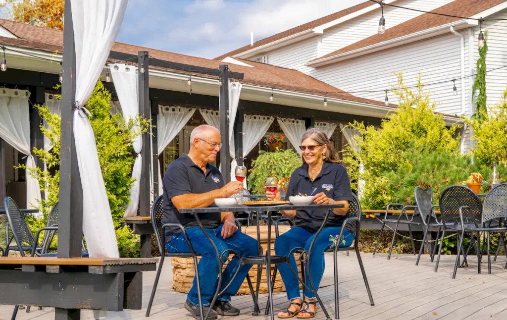 denis and rhonda brooks eating in the outside area of brooks estate