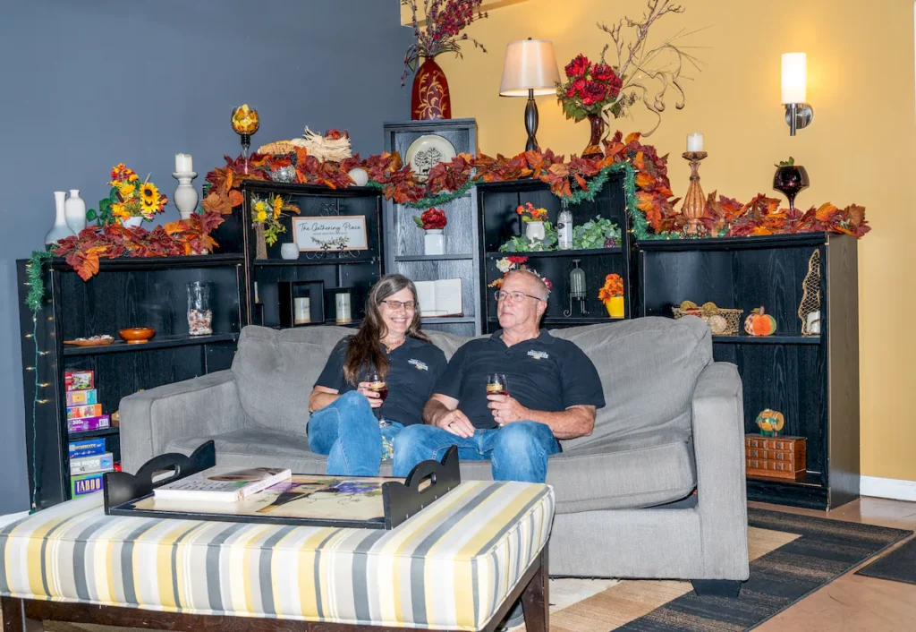 Denis and Rhonda Brooks sitting on couch The Gathering Place at The Inn Event Center at Deer Creek Winery at Brooks Estate