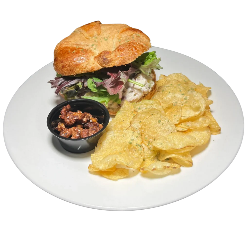 The Deer Creek Pairing Experience House Chicken Salad Croissant with cranberries and pecans on a buttery croissant at Deer Creek Winery Café